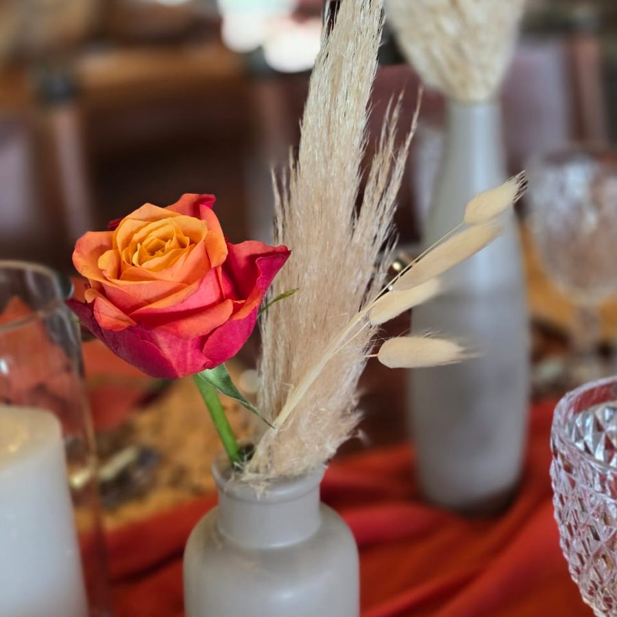 Table florals in bud vases with roses and pampas
