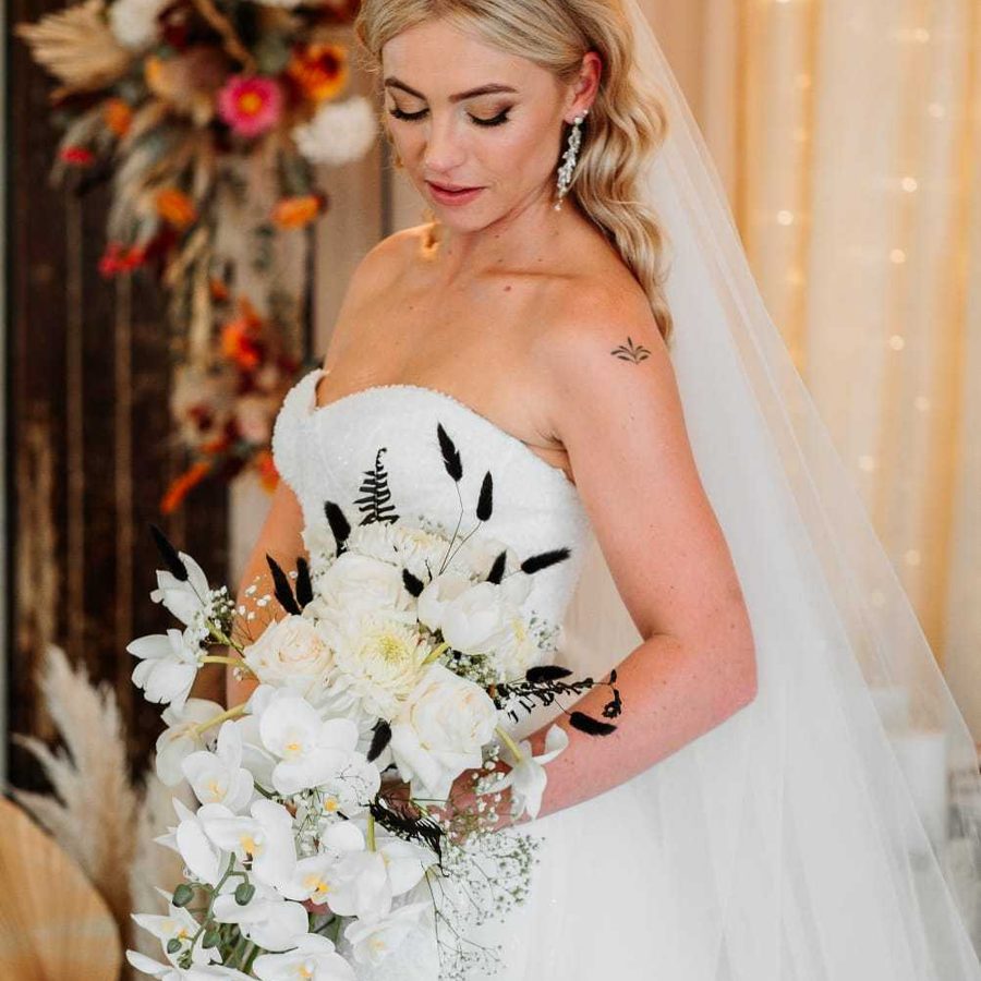 Bridal bouquet of white orchids and roses by Brighter Future Floral & Events